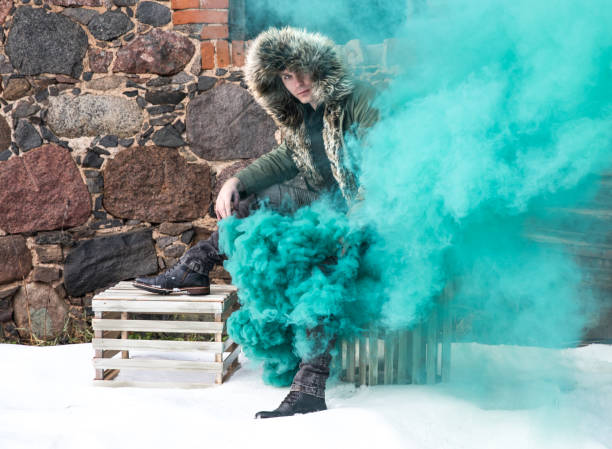 istock Young man posing with a smoke bomb. 901932348