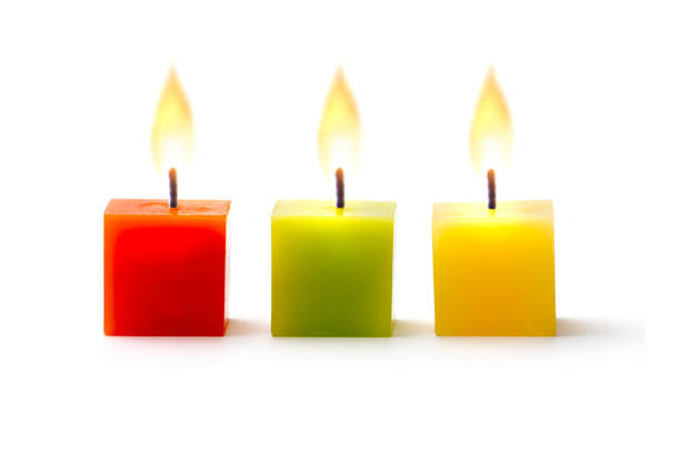 три красочные свечи куба в ряд на белом - candle candlelight red burning стоковые фото и изображения