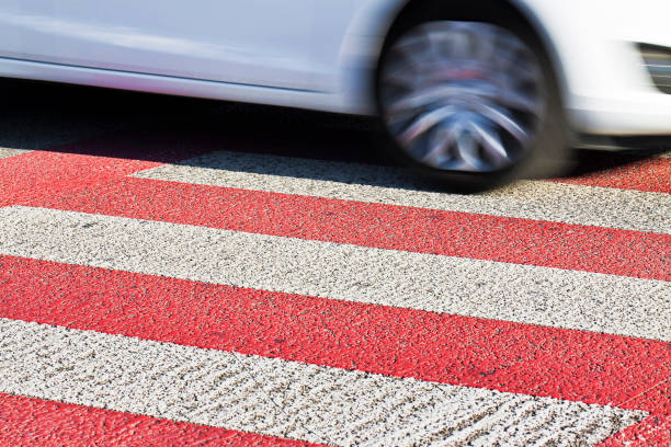 istock Black and white pedestrian crossing with white car on background - image with copy space 901936828