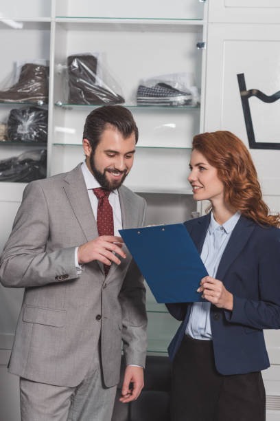 istock dry cleaning manageress writing order of handsome young man 901948806