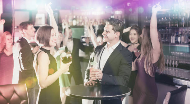 istock Colleagues dancing on corporate party with cocktails in hands 901949064