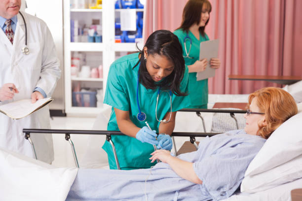 istock Young nurse concentrates while giving patient an injection 901949422
