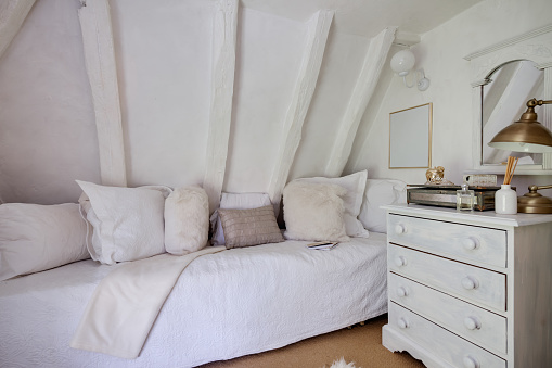 Small cottage bedroom beutifully decorated in shades of white 