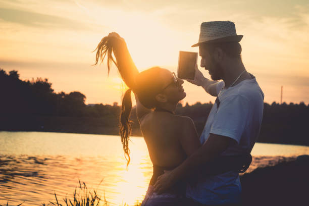 istock couple taking selfie by the lake 901953300