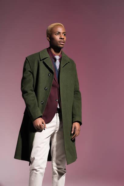istock man in cloak looking away on pink background 901953690