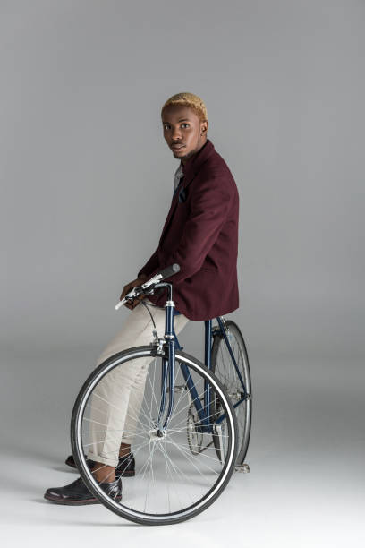 istock man sitting on bike and looking at camera 901953906