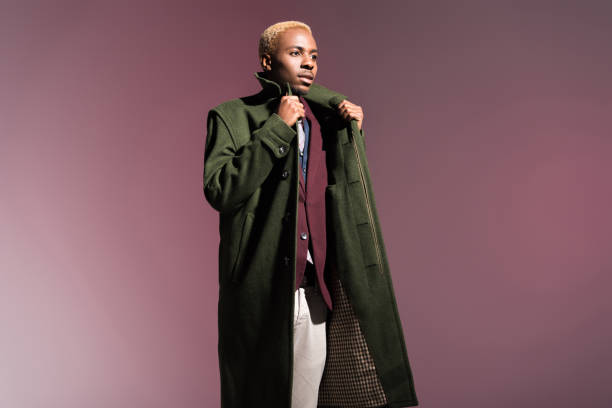 istock man in cloak looking away isolated on pink background 901956132