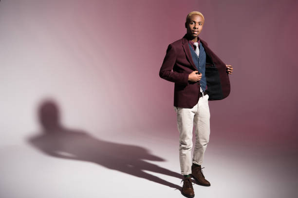 istock man in red jacket standing on pink background 901956558