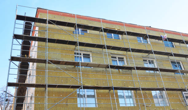 istock Solid wall insulation with rock wool. Energy efficiency house wall renovation for energy saving. Exterior house wall heat insulation with mineral wool. External wall insulation. 901959844