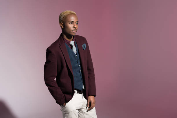 istock man in red jacket standing with hand in pocket 901959916