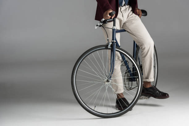 istock man siting on bike on grey background 901959986