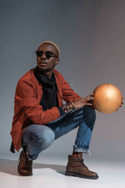 istock man sitting with basketball ball in hands 901964808