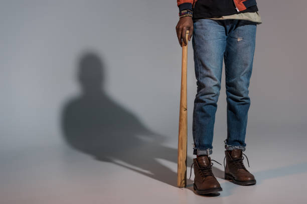 istock Partial view of guy leaning on baseball bat 901968760