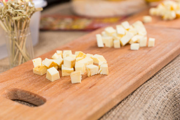 istock Sliced cheese on a wooden board in the kitchen 901968818