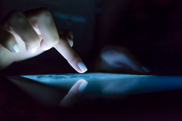 istock Woman's pointing finger with tablet glowing screen at home. 901977742