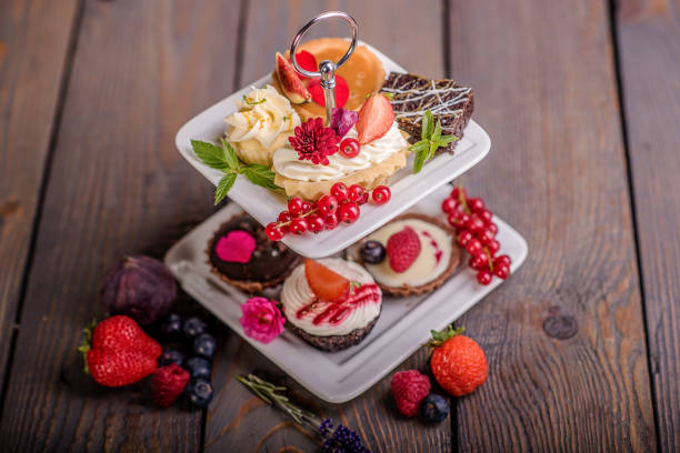 istock cake selection on white cake stand and wood background 901983550
