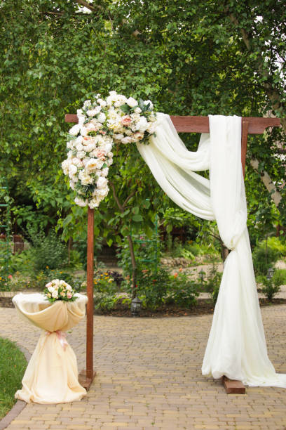 istock Wedding arch decorated with fresh flowers 901984126