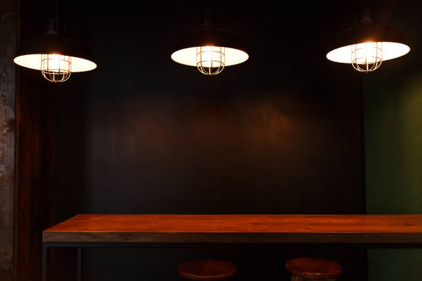 istock Loft interior concrete design, wooden table. Three light pendants in dark 901991624