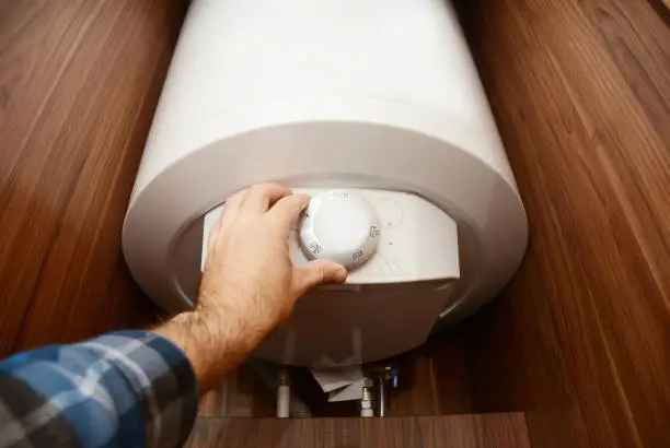 Man hand regulate heat in Condensing Boiler, Combi Boiler for house energy saving. Gas Boiler, Boiler Supplies Concept.