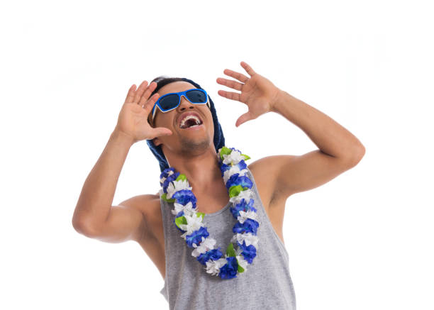 Very cheerful and crazy man. Young black man wears sunglasses, flower necklace and cap. Dressed for Carnival, traditional Brazilian party.