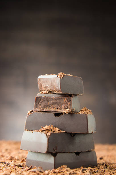 istock Chocolate bars on a wooden background. Chocolate candies. 902002516