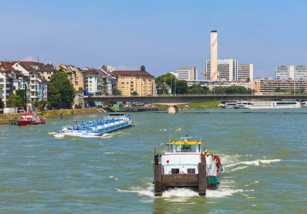 Basel, Switzerland - 6 August, 2014: the Rhine river and buildings of the city of Basel along it. Basel is a city on the Rhine river in northwestern Switzerland, located where the Swiss, French and German borders meet.