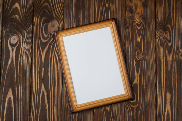 istock Dark wooden frame with an empty picture, on a wooden dark background. 902003814