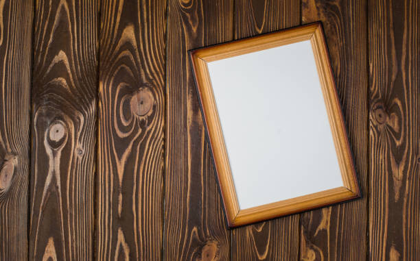 istock Dark wooden frame with an empty picture, on a wooden dark background. 902003856