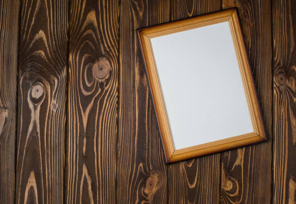 istock Dark wooden frame with an empty picture, on a wooden dark background. 902003890