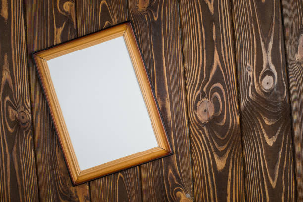 istock Dark wooden frame with an empty picture, on a wooden dark background. 902003938
