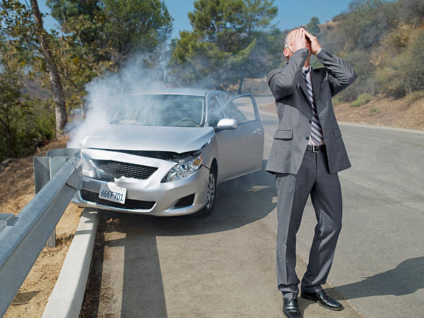 Frustrated businessman standing next to car wrecked on guardrail  rail car stock pictures, royalty-free photos & images