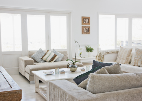 Living room interior with modern orange armchairs. Minimalism concept. 3d render image.