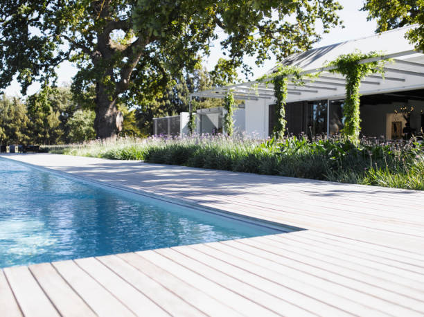 Poolside by swimming pool of modern home  patio deck stock pictures, royalty-free photos & images