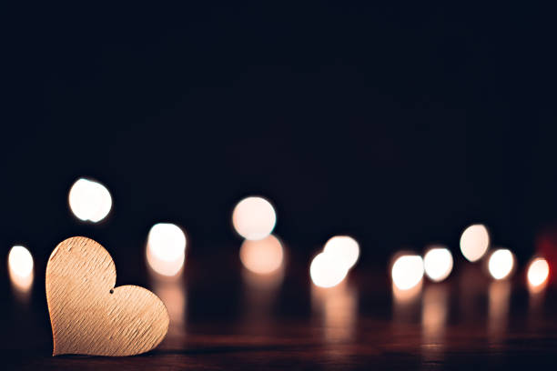 istock Plywood heart with christmas lights on a table 902021634