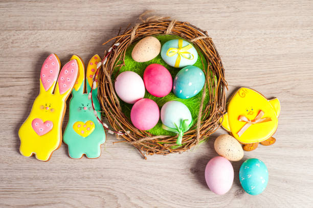 istock Easter composition of the branches,Easter bunny, cakes, tulips colored eggs cooked for the holiday on the wooden background 902024728