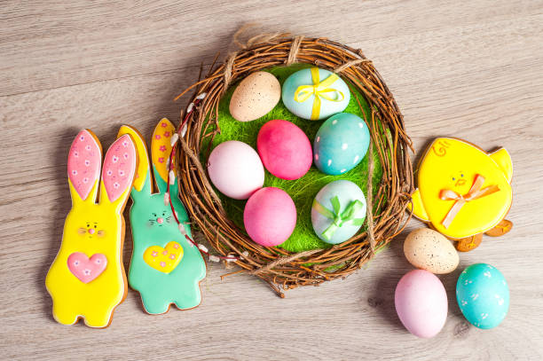 istock Easter composition of the branches,Easter bunny, cakes, tulips colored eggs cooked for the holiday on the wooden background 902024864