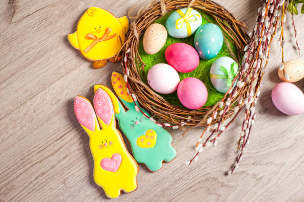 istock Easter composition of the branches,Easter bunny, cakes, tulips colored eggs cooked for the holiday on the wooden background 902026498