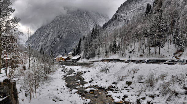 istock winter landscape in the Alps with the river and clouds 902030004