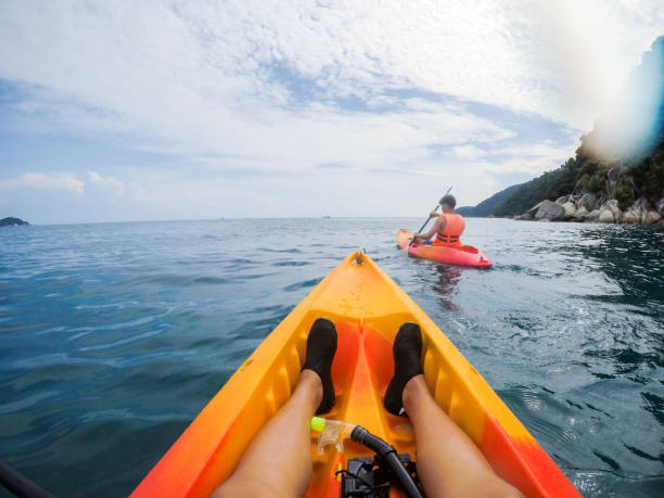 POV Sports - Personal perspective of woman and a boy kayaking on beautiful South China Sea, Perhentian Island Malaysia stock photo