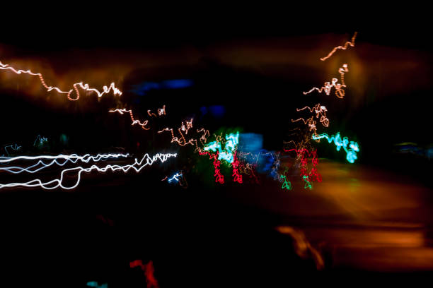 istock abstract background blurred colored marks from fast moving cars night 902035254
