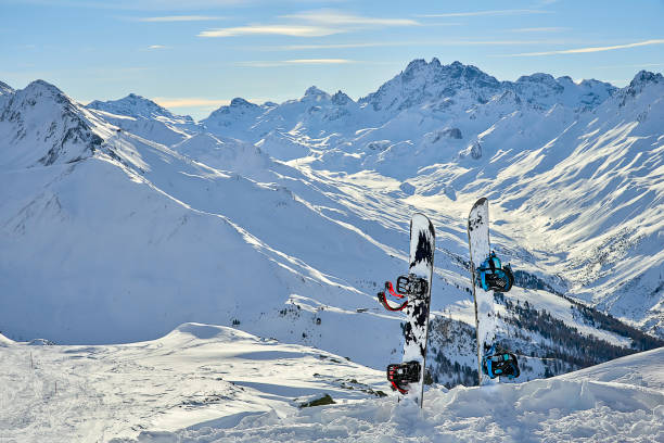 istock Snowboard in snow on off-piste slope at sun day between mountains on the background 902038596