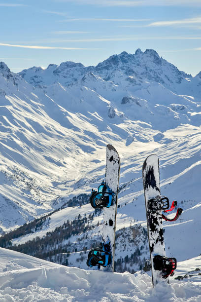 istock Two snowboard standing upright in snow between mountains on the background 902038612