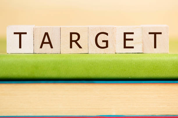 istock Target word built with letter cubes on green book 902045814
