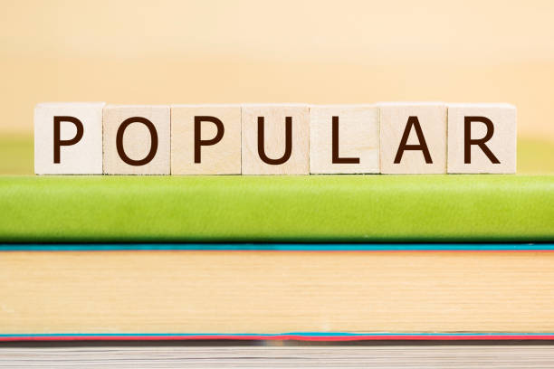 istock Popular word built with letter cubes on green book 902046002