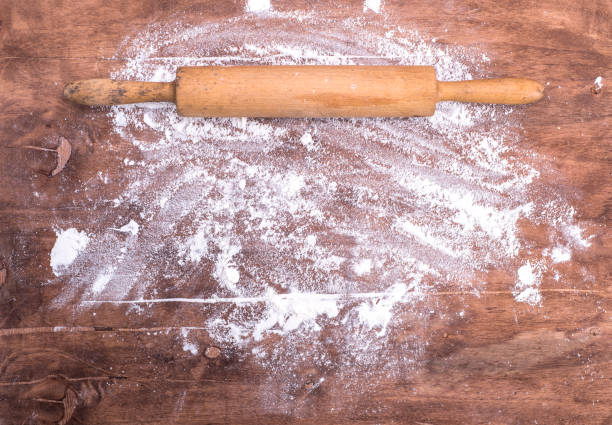 istock scattered flour on a brown wooden table 902046088