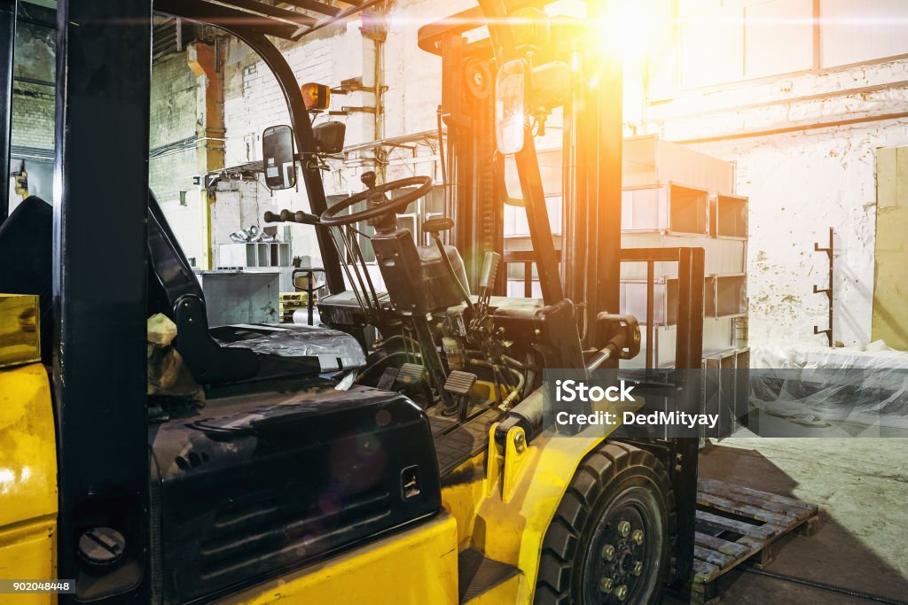 Close up of Forklift Truck inside warehouse or factory or logistics company Close up of Forklift Truck inside warehouse or factory or logistics company, sunlight effect Forklift Stock Photo