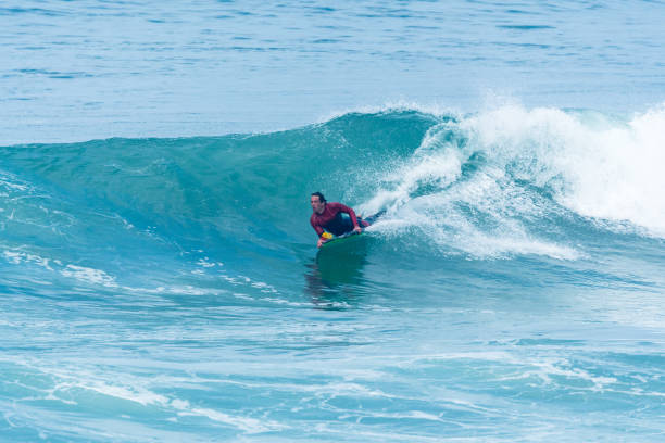 istock Bodyboarder surfing ocean wave 902051358