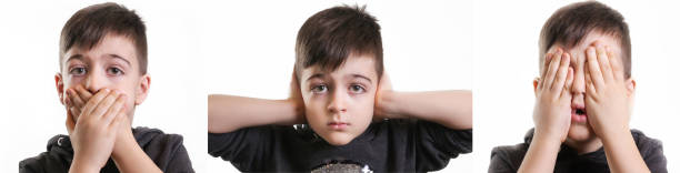istock Studio portrait of young boy - see no evil, hear no evil, talk no evil concept 902055978