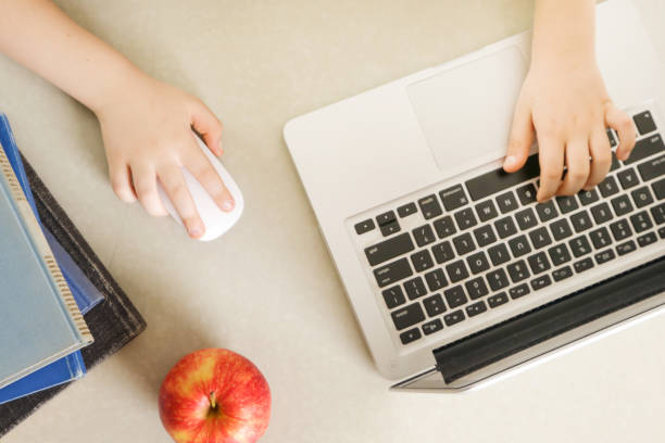 Books, apple and laptop on the working desk - top view Books, apple and laptop on the working desk - top view apple keyboard stock pictures, royalty-free photos & images