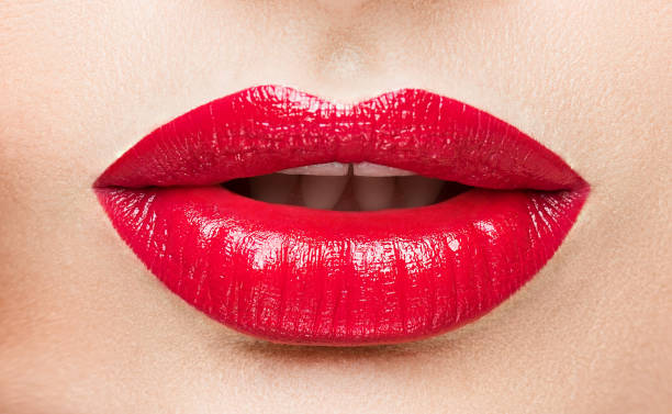 istock The female lips which are made up by red lipstick. 902077452
